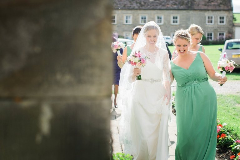 bride and bridesmaid smiling