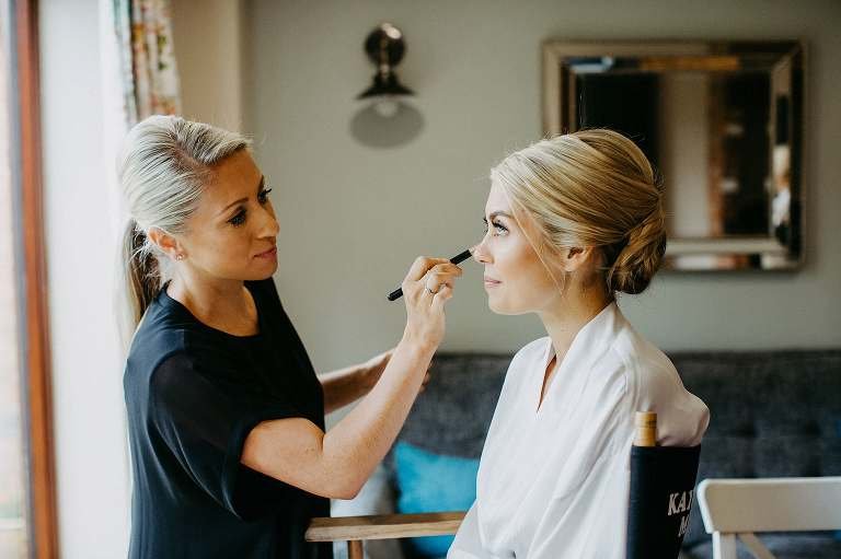 bride having make-up applied