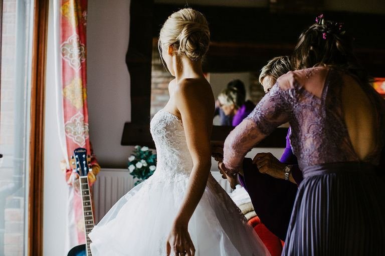 bride getting into her pronovias dress
