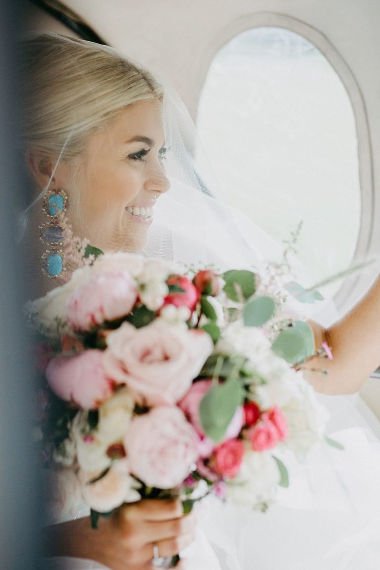 bride smiling in her classic car