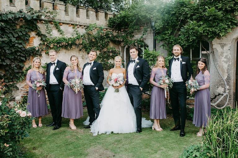 portrait of wedding party in Holme Pierrepont Hall wedding garden